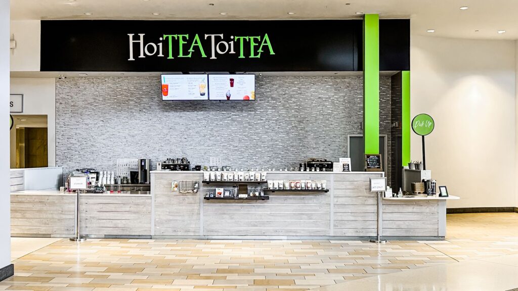 Wide view of HoiTea ToiTea retail shop showcasing bright interior design and branding.