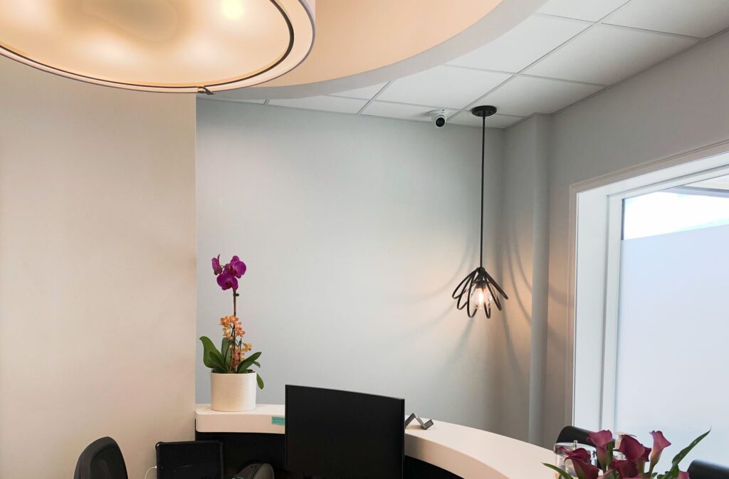Reception nook with pendant light and modern finishes highlighting wellness-focused office design.