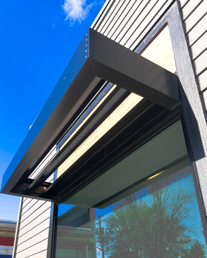 Exterior awning and glass storefront illustrating modern medical office architecture by healthcare architects near Indianapolis.
