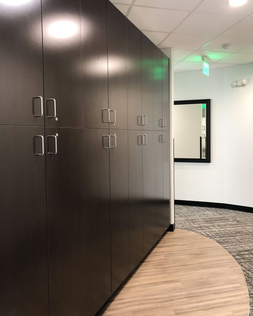 Dark cabinetry and storage solutions in the remodel by commercial interior design Indianapolis firms.