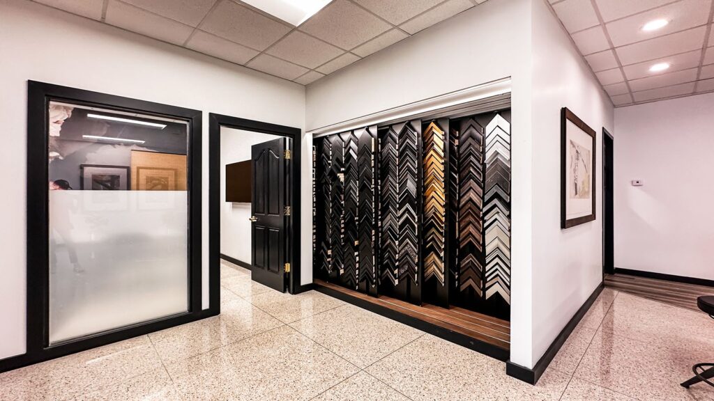 Creative hallway with display of custom frame samples and artwork.