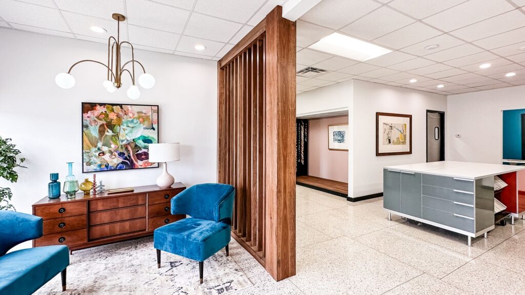 Open office interior with modern cabinetry and framed artwork display.