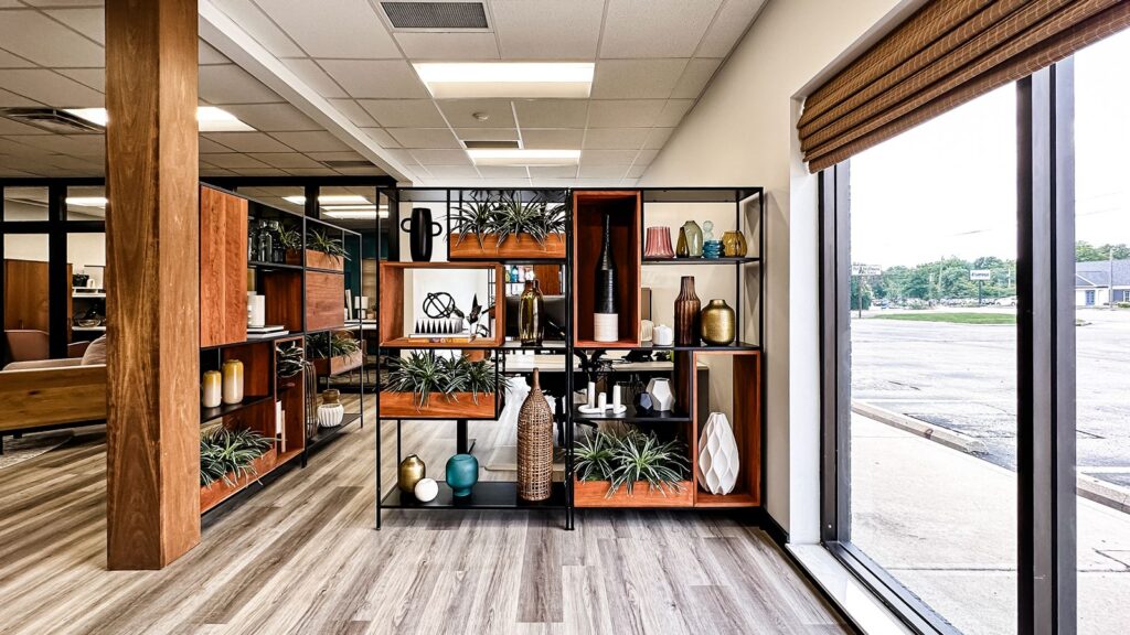 Creative studio lounge with mid-century modern furniture and open shelving.