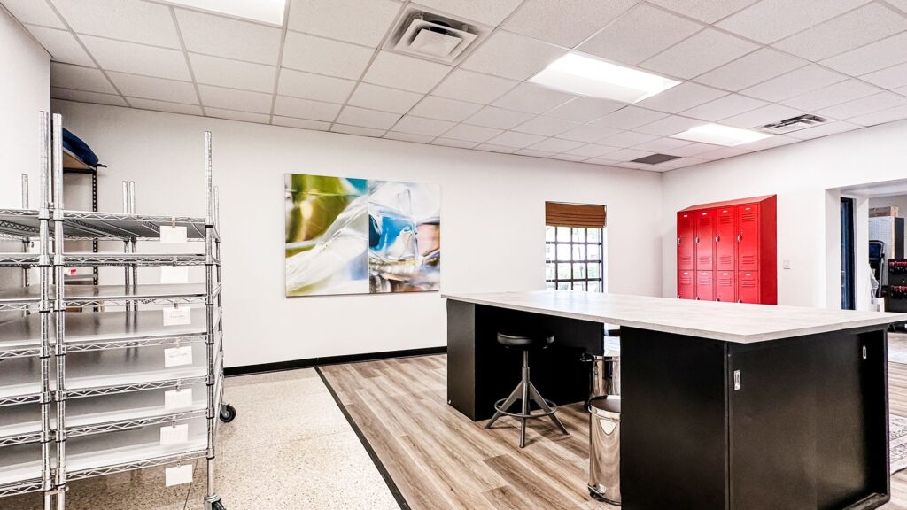 Reception area featuring terrazzo flooring, red accent cabinetry, and open layout design.