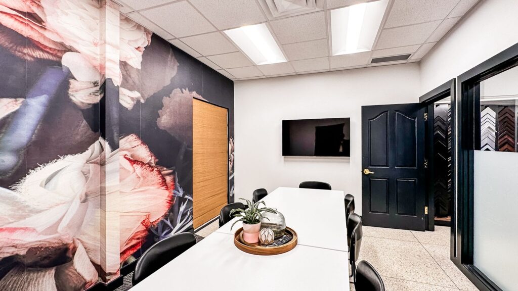 Private meeting room with oversized wall art and black trim detailing.