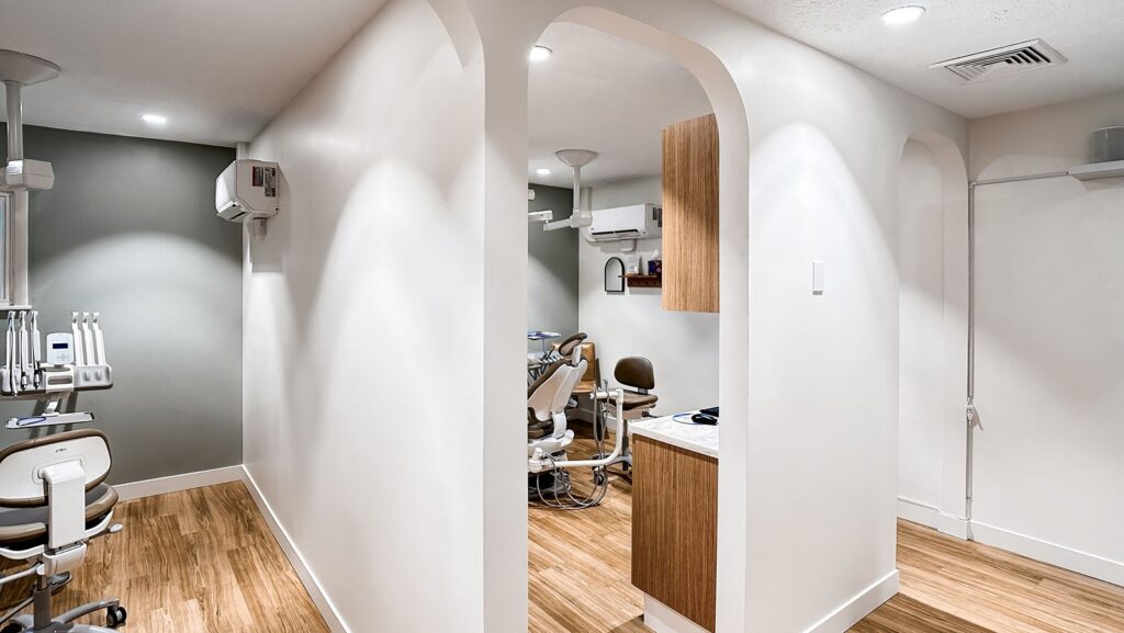 Open clinical layout with dental chairs and custom millwork cabinetry.