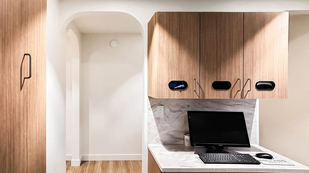 Compact dental workspace with ergonomic setup and integrated cabinetry.
