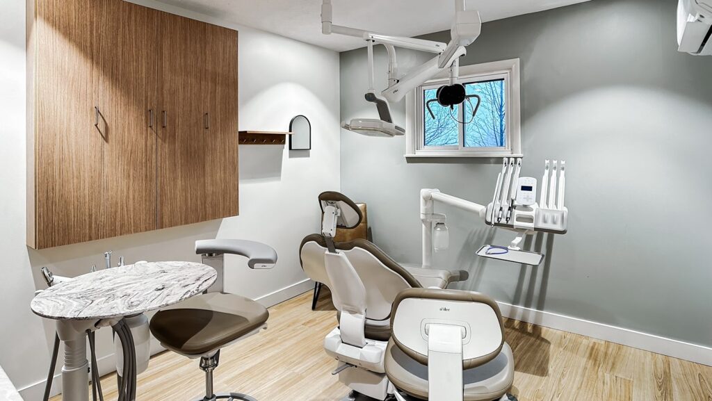 Operatory detail with curved archways and wood finishes in modern healthcare interior.