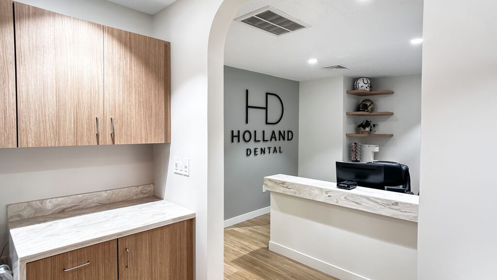 Front desk with custom cabinetry and clean, contemporary dental office design.