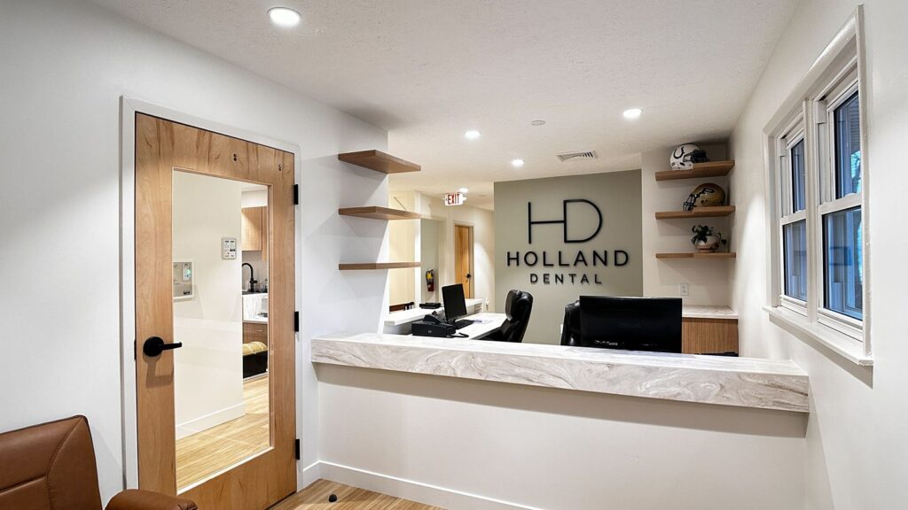 Operatory featuring curved ceiling details and light wood cabinetry in modern dental clinic.