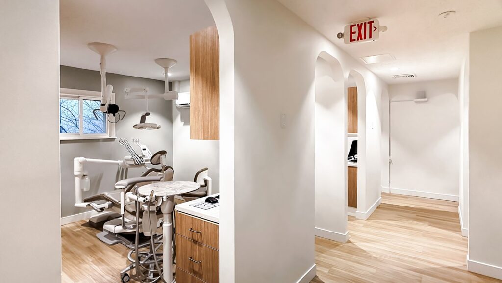 Open hallway leading to operatories in residential-to-commercial dental conversion.