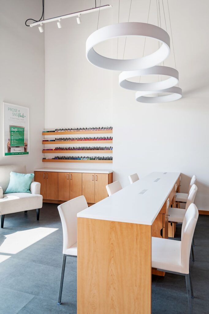 Reception area with wood finishes and pink accent wall design.
