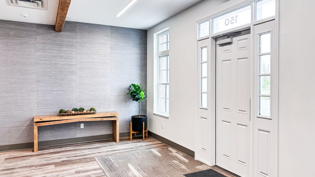 Lobby bench seating and neutral tones highlighting thoughtful office design services and natural materials.