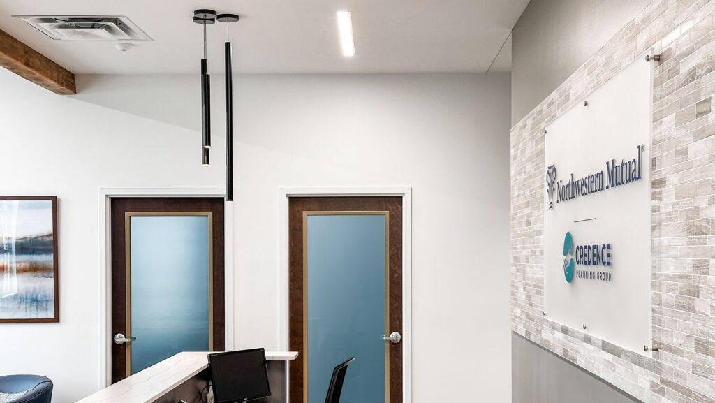 Frosted glass doors and signage designed by corporate architecture firm showcasing clean, professional design aesthetics.