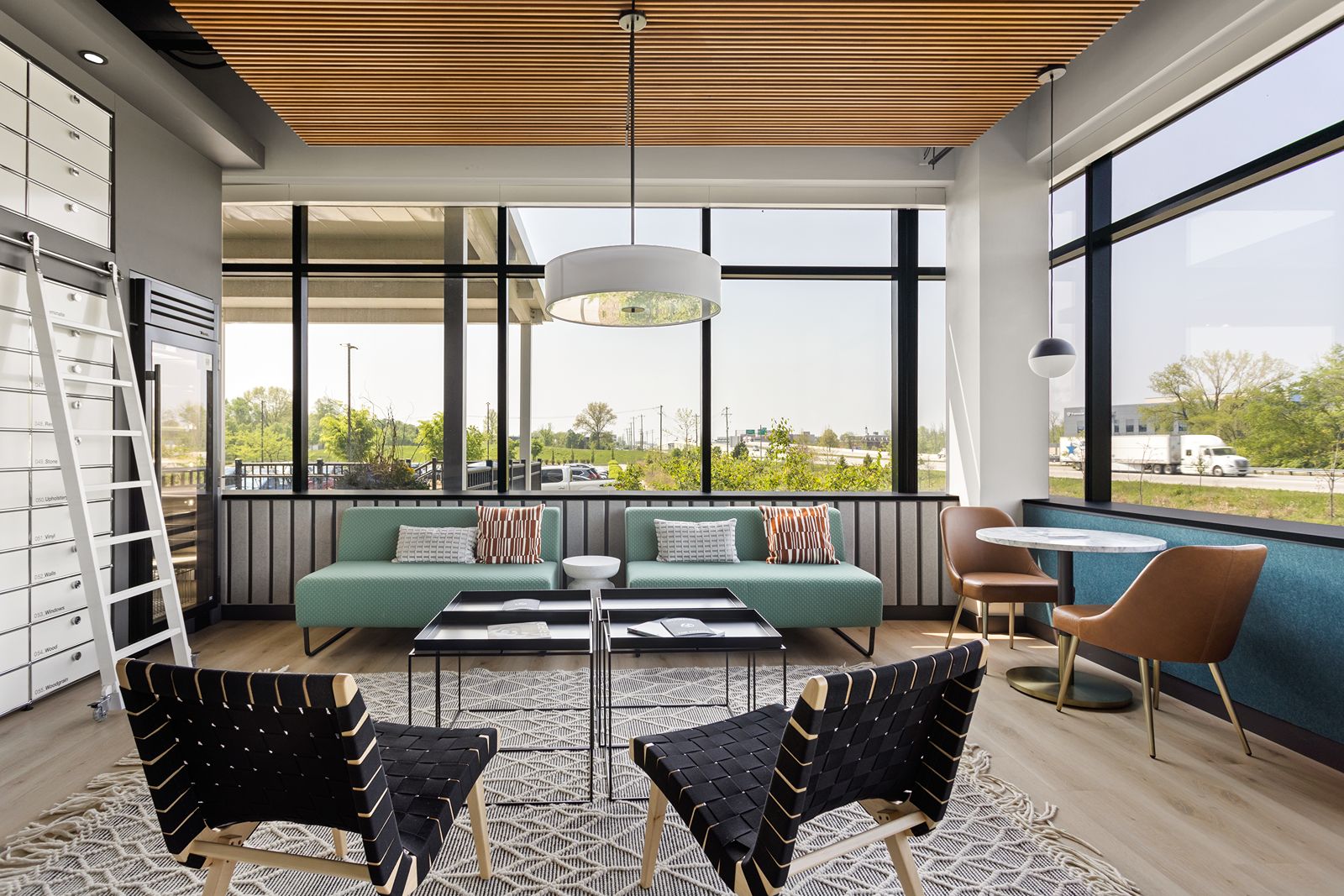 Modern lounge area with natural light, soft seating, and contemporary showroom design by interior designer Indianapolis.