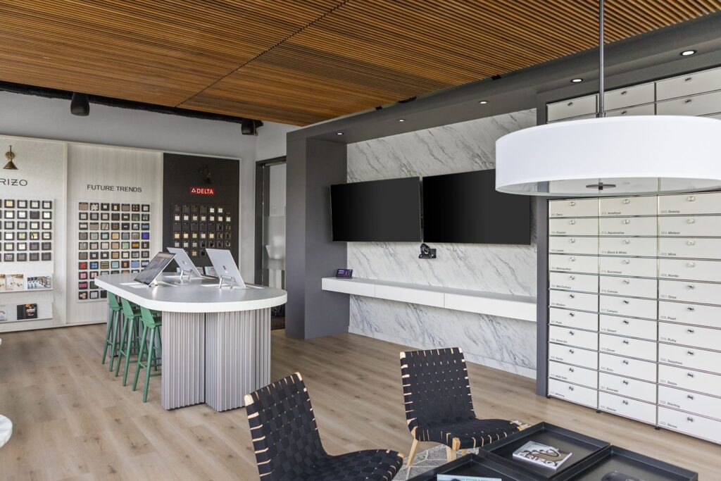 Media wall with mounted screens and built-in cabinetry for design presentations and product demos.
