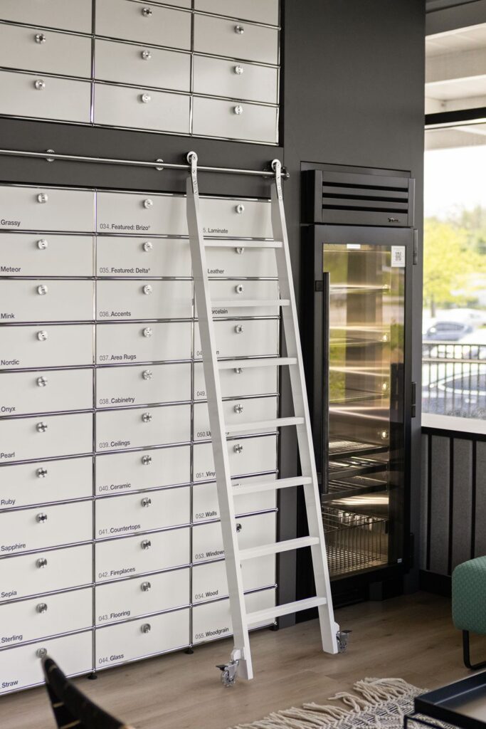 Entryway to design resource center featuring glass door and modern industrial interior design.