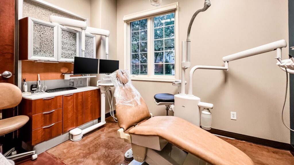 Operatory featuring tan dental chair and window views.