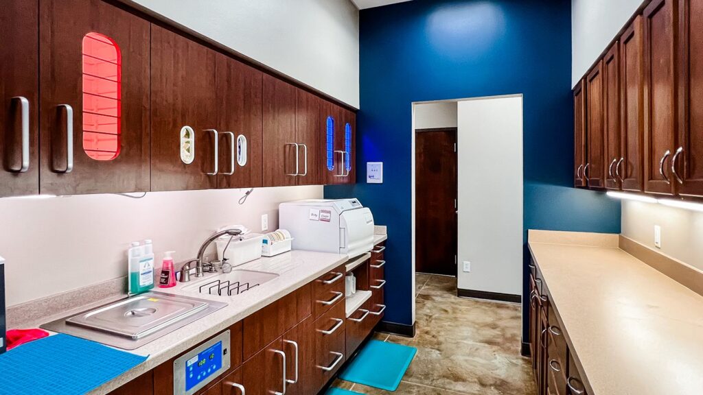 Sterilization room with wood cabinetry and white countertop.