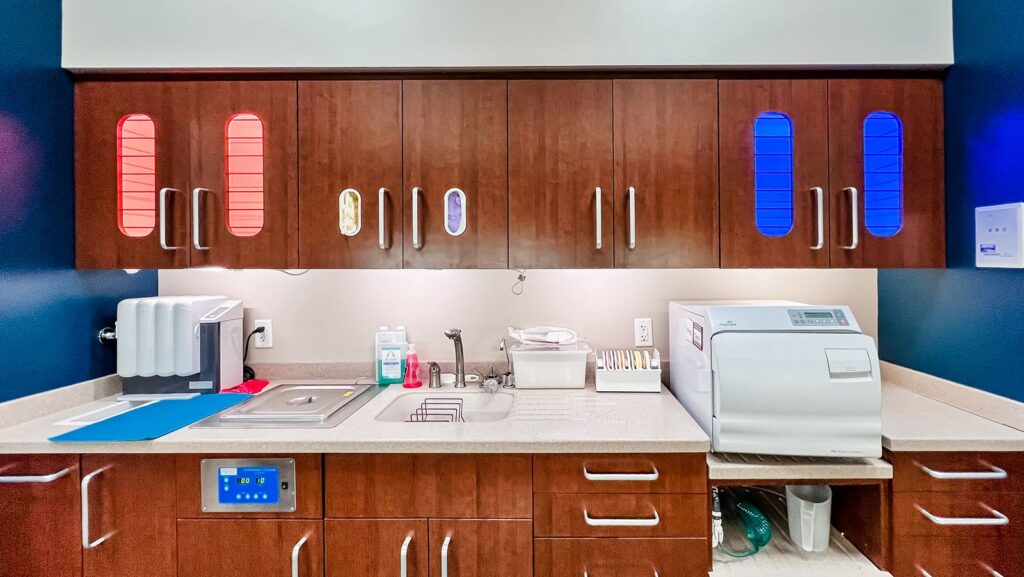 Sterilization room with wood cabinetry and white countertop.