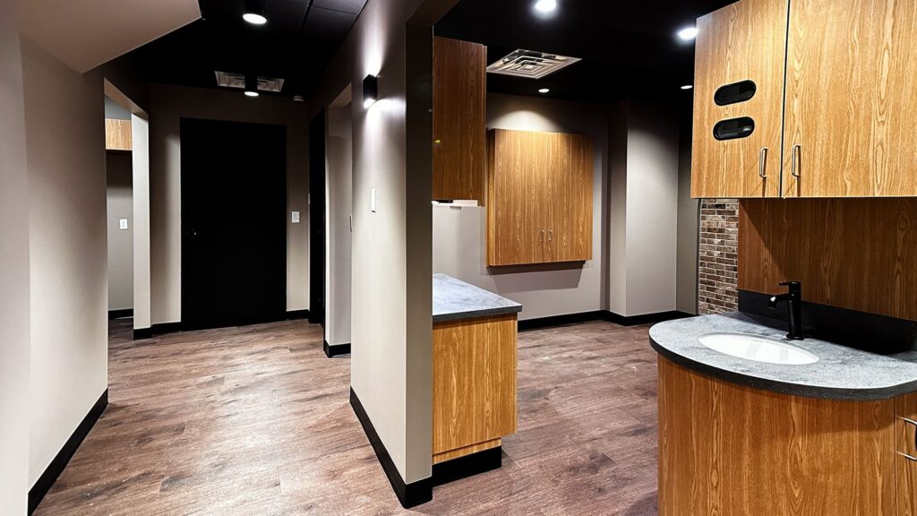 Hallway and cabinetry design with soft lighting and modern medical office interior planning.