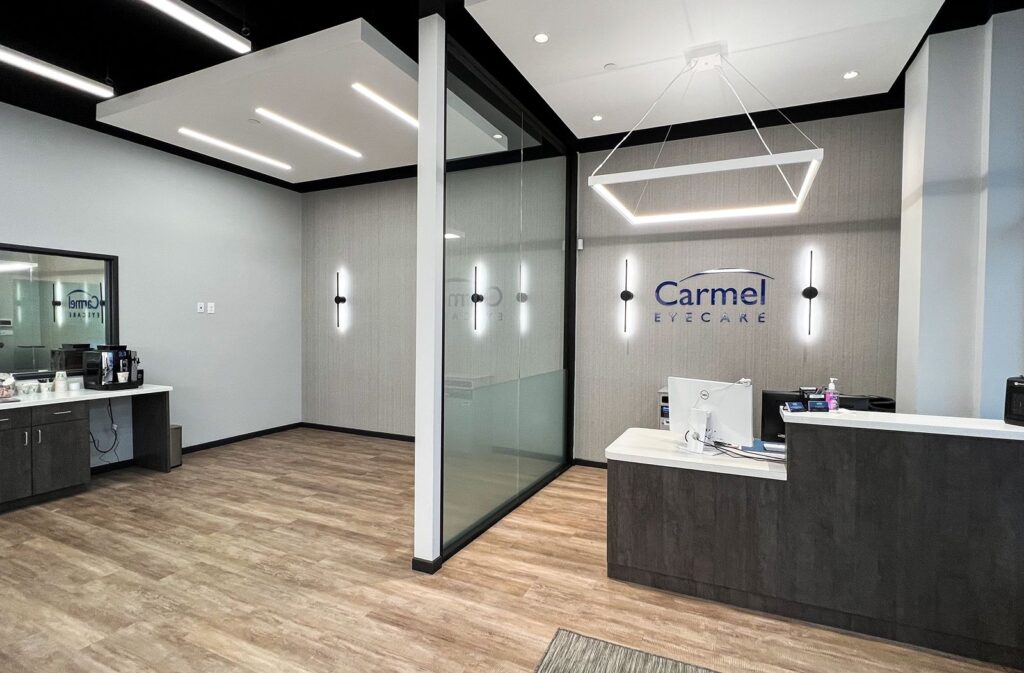 Reception area for Carmel Eyecare showcasing minimalist modern finishes and commercial interior design Indianapolis.