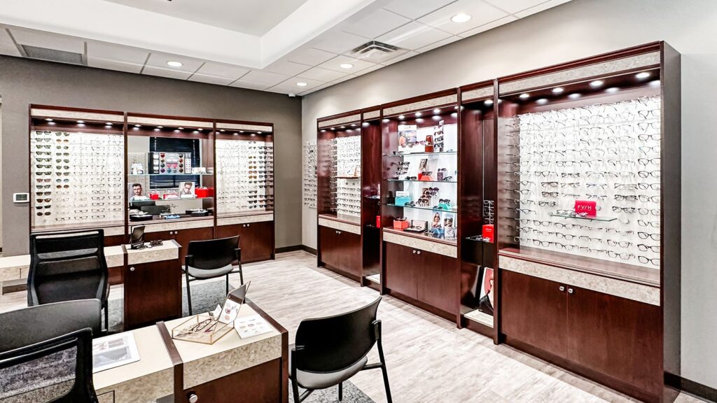 Front desk and optical retail space with warm wood finishes.