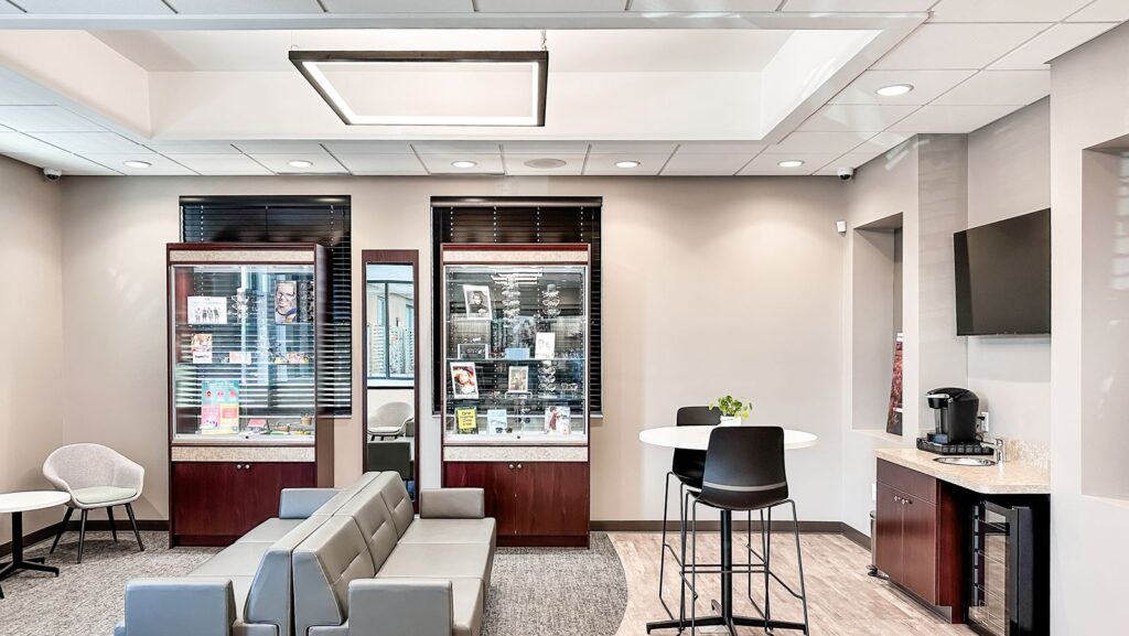 Reception desk and eyewear display showcasing custom cabinetry.