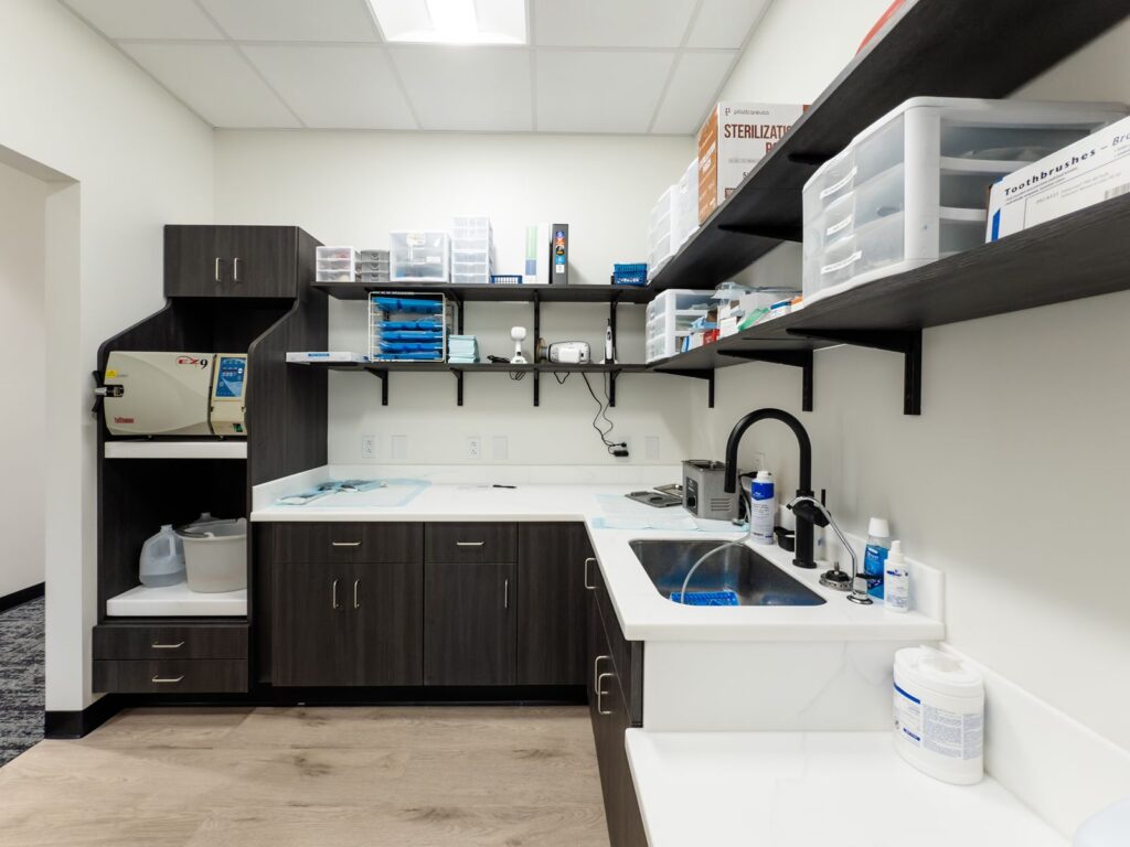 Dental lab area with sinks and organized cabinetry.