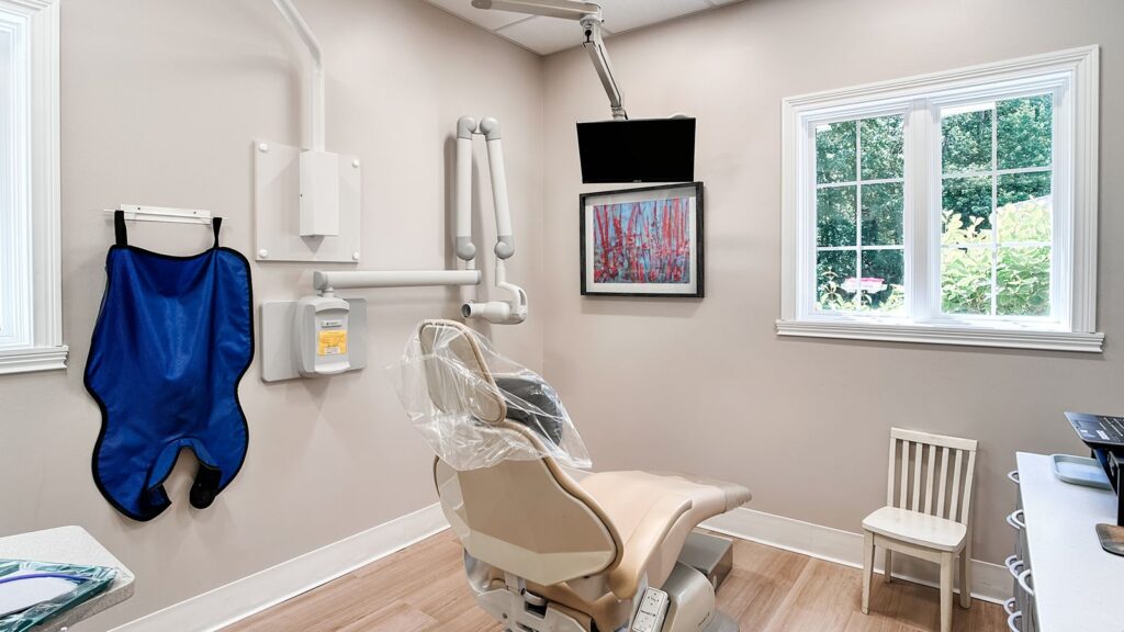 Exam room setup with dental equipment and patient chair.