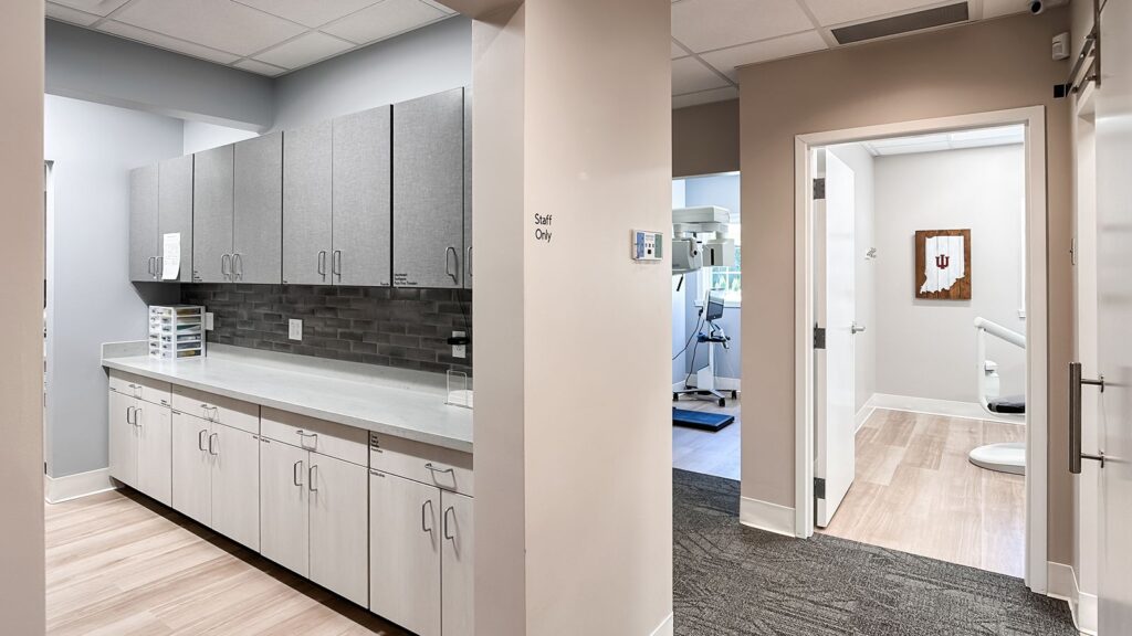 Hallway leading to treatment rooms in a modern dental office.