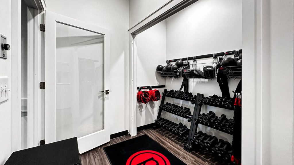 Equipment storage area with weights and resistance bands neatly organized.