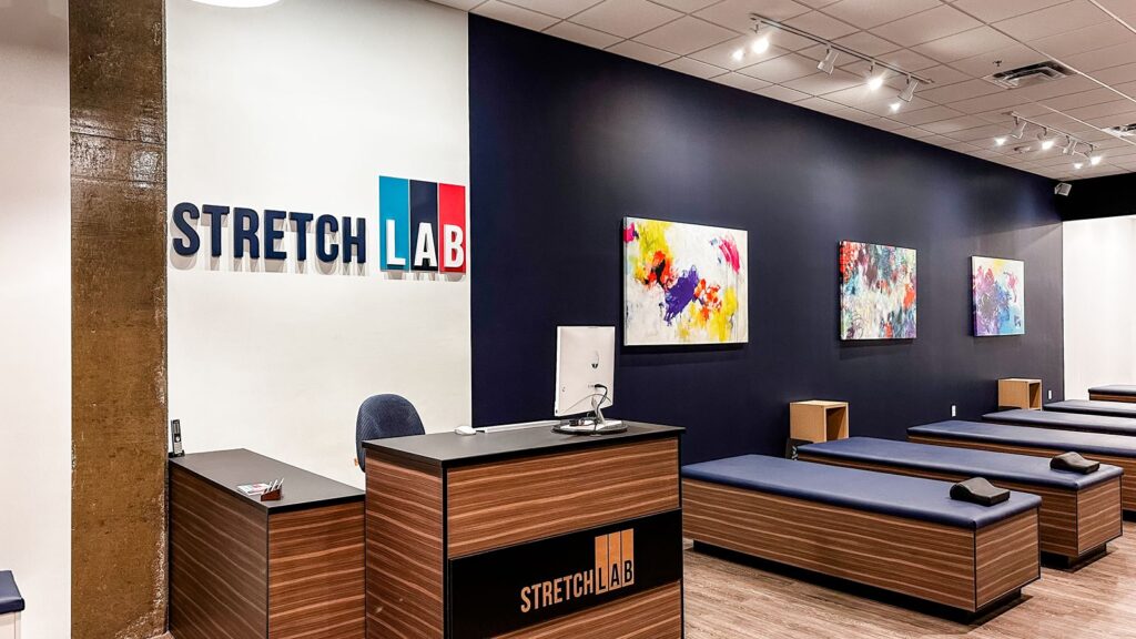 Stretching stations arranged along navy and white interior walls.