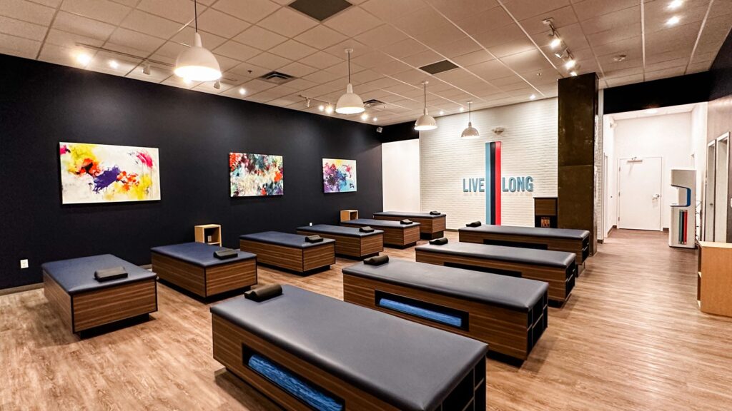 Interior view highlighting navy walls, exposed beams, and bench layout.