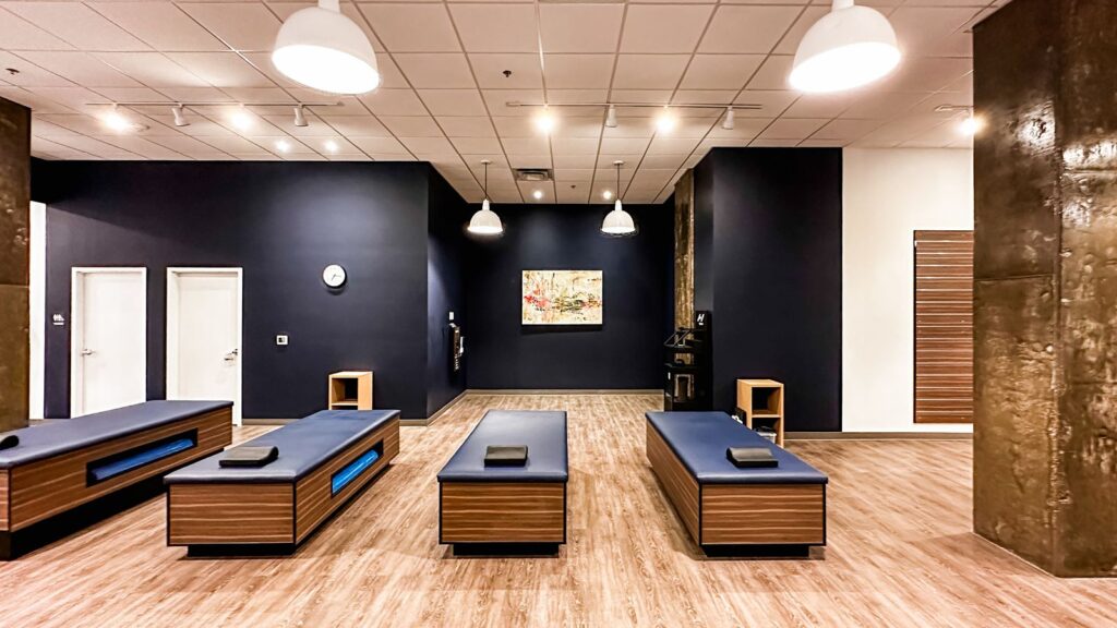 Stretching stations arranged along navy and white interior walls.