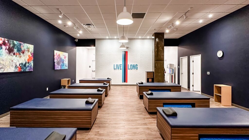 Individual stretching benches with colorful wall art and soft lighting.