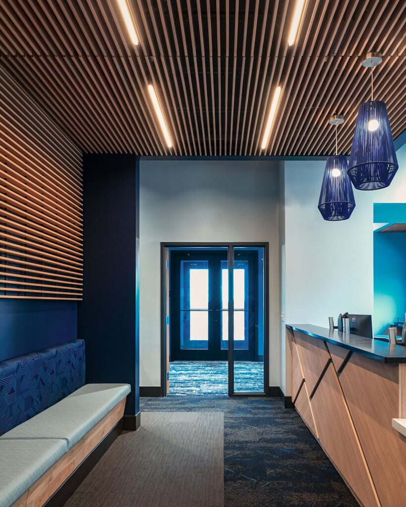 Healthcare interior design firms showcasing modern dental office renovation with wood detailing.