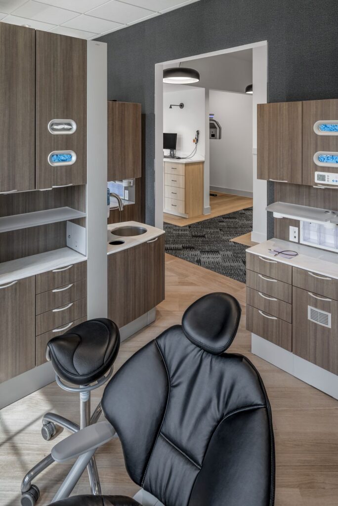 Private meeting space with black round table and modern lighting designed for patient consultations.