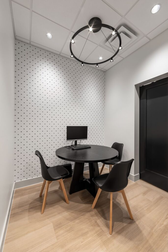 Consultation room with black and white accents and soft lighting designed by interior designer Indianapolis.