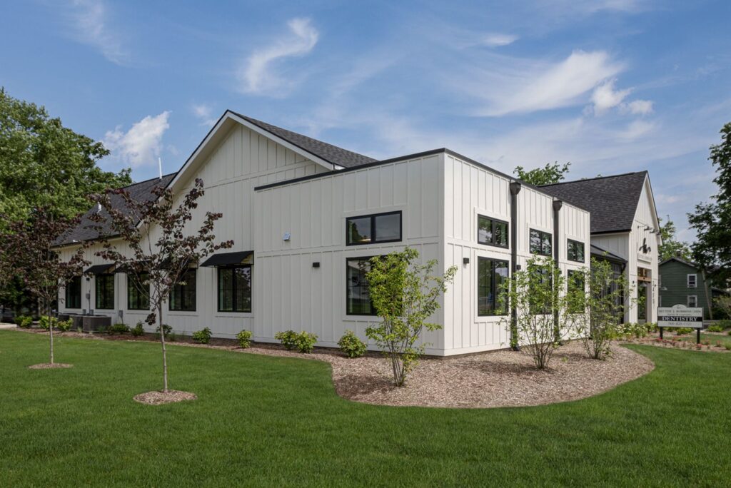 Rear exterior view of dental office showcasing black and white façade and modern healthcare architecture.