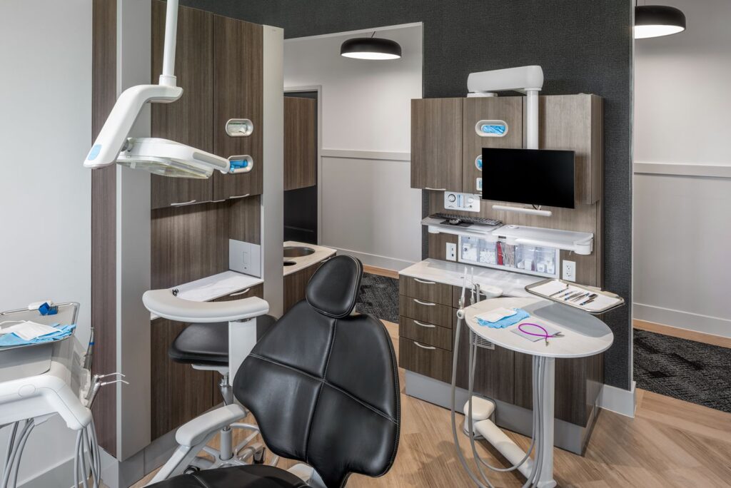 Private dental operatory with ergonomic chair and cabinetry showcasing modern dental office interior design.