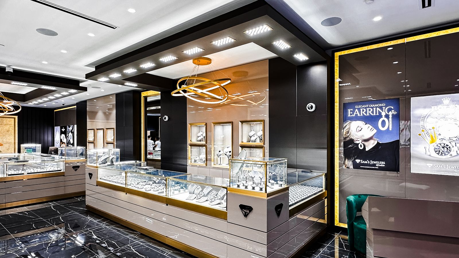 Modern jewelry store with glass display cases and gold lighting.