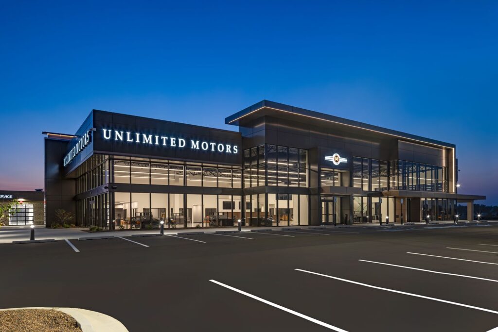 Evening exterior of Unlimited Motors Westfield illuminated with architectural lighting and sleek contemporary finishes.