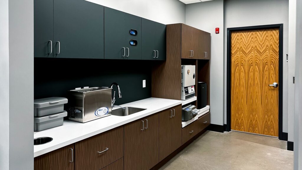 Sterilization room with dark cabinetry and commercial interior design Indianapolis.