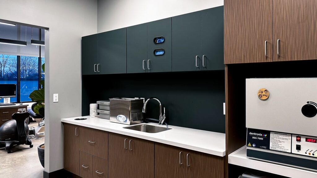Sterilization room with dark cabinetry and commercial interior design Indianapolis.
