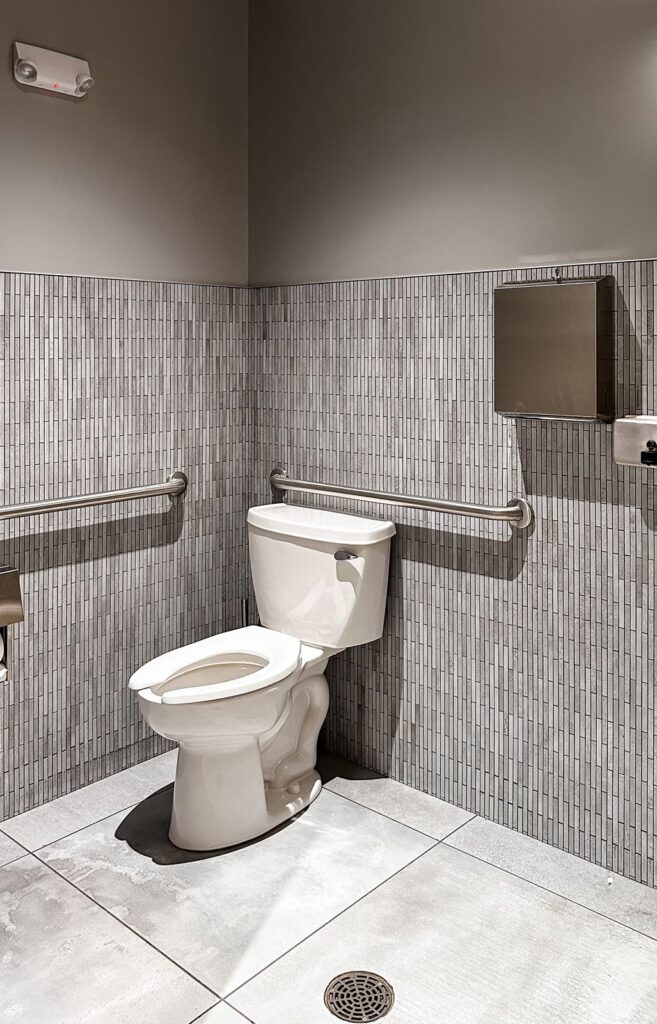 Private restroom featuring wall tile detail and clean minimalist design.