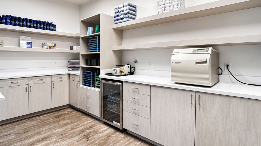 Sterilization room with open shelving, modern cabinetry, and dental equipment.