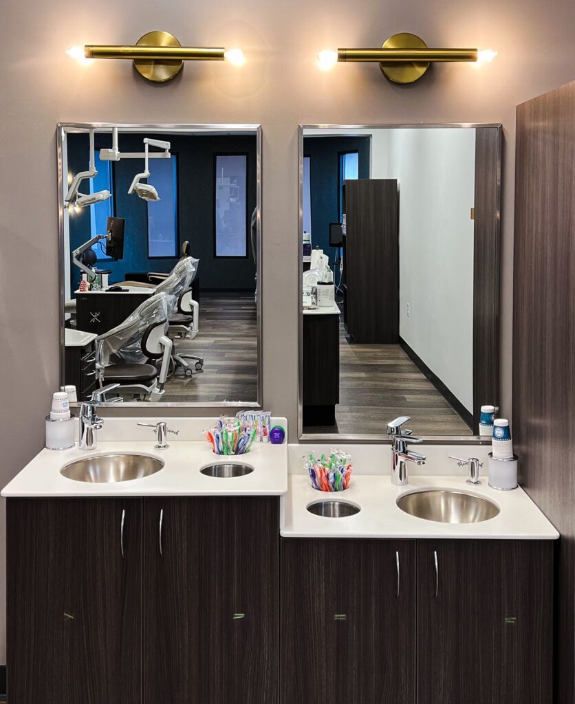 Treatment sinks and prep area featuring sleek cabinetry and medical office interior design details.