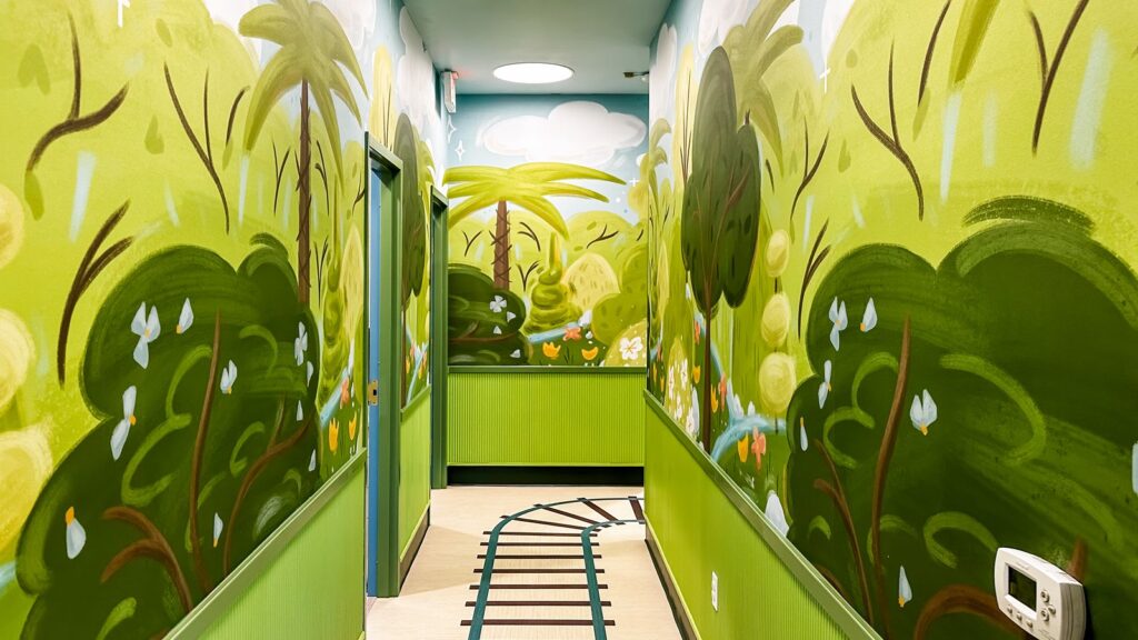 Dental operatory featuring space-themed mural and creative pediatric dental architecture details.