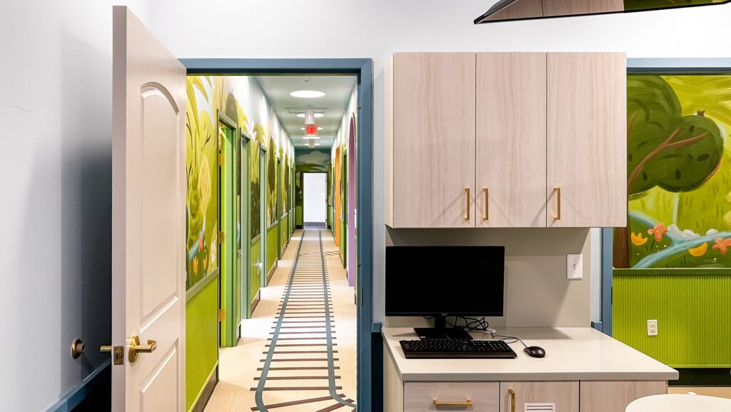Colorful corridor with archways and vibrant wall designs by dental clinic interior design specialists.